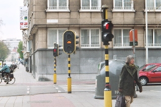 The pedestrian light is red, the bike light is yellow, and the auto light (out of view) is still green